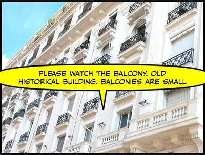 a white building with a yellow sign in front of it at New - cosy & nice Apartment in Palais Miramar in Cannes