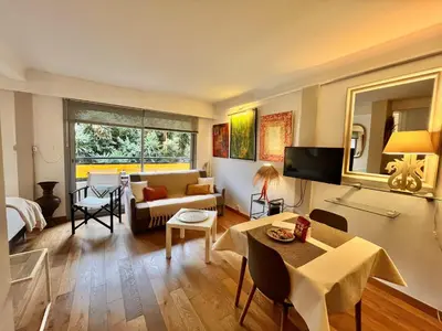 a living room with a couch and a dining room at Rouaze by Welcome to Cannes in Cannes