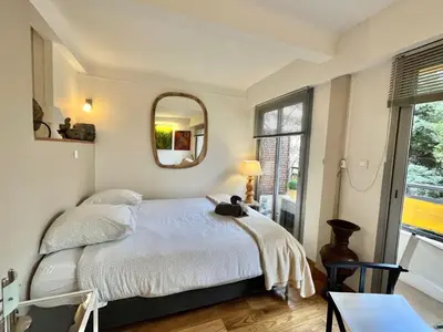 a bedroom with a bed and a mirror at Rouaze by Welcome to Cannes in Cannes