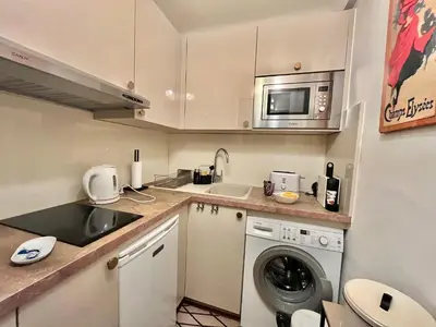 a small kitchen with a sink and a washing machine at Rouaze by Welcome to Cannes in Cannes