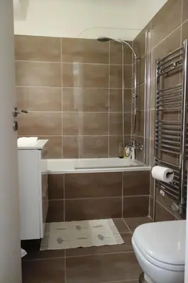 a bathroom with a shower and a toilet and a tub at Rouaze by Welcome to Cannes in Cannes