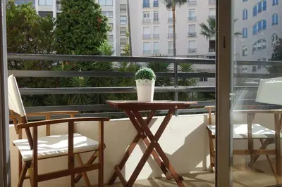 a table and two chairs on a balcony at Rouaze by Welcome to Cannes in Cannes