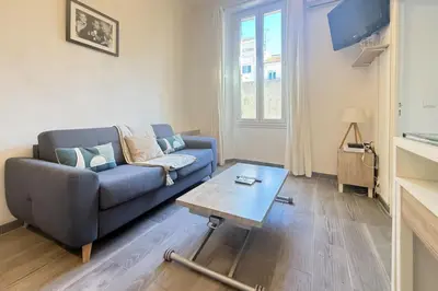 a living room with a blue couch and a coffee table at 1-bedroom appartement in the center of Cannes in Cannes