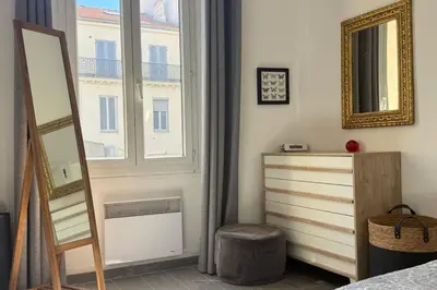 a bedroom with a dresser and a window at 1-bedroom appartement in the center of Cannes in Cannes