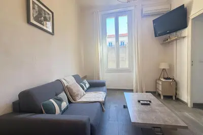 a living room with a blue couch and a coffee table at 1-bedroom appartement in the center of Cannes in Cannes