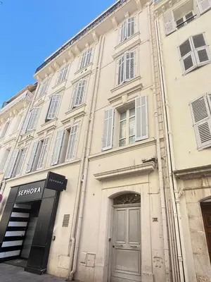 a large white building with a door in front of it at 1-bedroom appartement in the center of Cannes in Cannes