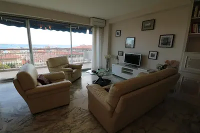 a living room with two couches and a television at 4 bedroom 3 bathrooms sea view Forville Apartment5 mins from the Palais Parking in Cannes