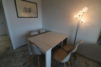 a white table and chairs in a room at 4 bedroom 3 bathrooms sea view Forville Apartment5 mins from the Palais Parking in Cannes