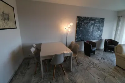a dining room with a table and chairs at 4 bedroom 3 bathrooms sea view Forville Apartment5 mins from the Palais Parking in Cannes