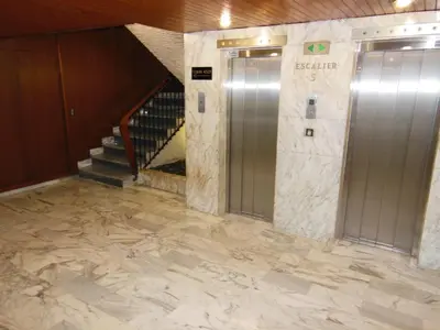 a lobby with two elevators and a staircase in a building at 4 bedroom 3 bathrooms sea view Forville Apartment5 mins from the Palais Parking in Cannes