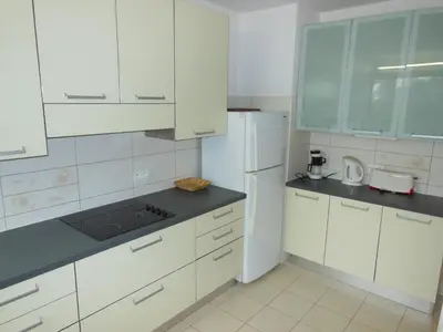 a kitchen with white cabinets and a white refrigerator at 4 bedroom 3 bathrooms sea view Forville Apartment5 mins from the Palais Parking in Cannes
