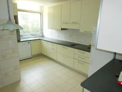 a kitchen with white cabinets and a window at 4 bedroom 3 bathrooms sea view Forville Apartment5 mins from the Palais Parking in Cannes