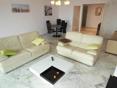 a living room with two couches and a table at 4 bedroom 3 bathrooms sea view Forville Apartment5 mins from the Palais Parking in Cannes