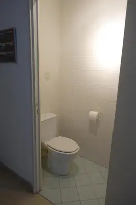 a bathroom with a toilet and a roll of toilet paper at Eden Beach in Cannes