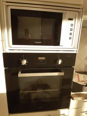 a microwave oven sitting on top of a stove at Eden Beach in Cannes