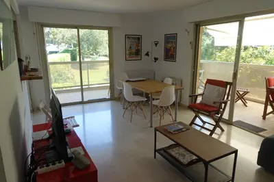 a living room with a table and chairs at Eden Beach in Cannes