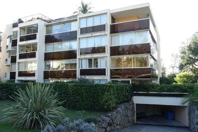 an apartment building with windows and bushes at Eden Beach in Cannes