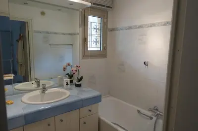 a bathroom with a sink and a bath tub and a sink at Eden Beach in Cannes