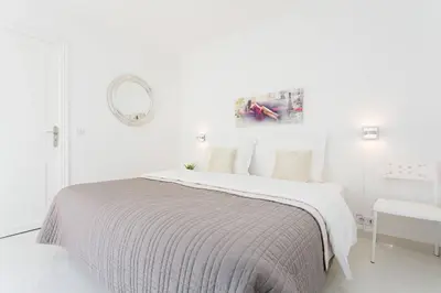 a white bedroom with a bed and a mirror at MARRIOTT/ CROISETTE - LUXE 1 BED in Cannes
