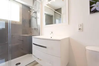 a white bathroom with a sink and a shower at MARRIOTT/ CROISETTE - LUXE 1 BED in Cannes
