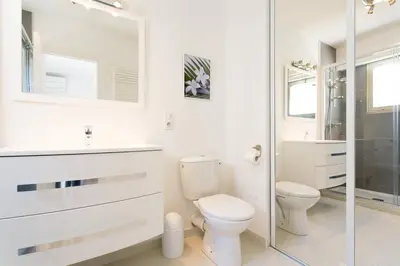 a white bathroom with a toilet and a shower at MARRIOTT/ CROISETTE - LUXE 1 BED in Cannes