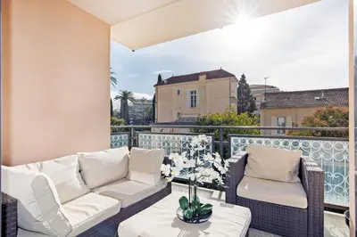 a patio with two couches and a table on a balcony at 3 bedrooms: 200m from Croisette in Cannes