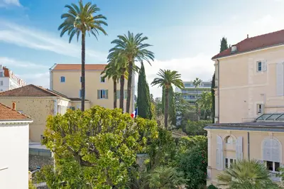 a view of a city with palm trees and buildings at 3 bedrooms: 200m from Croisette in Cannes
