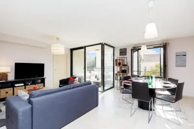 a living room with a blue couch and a table at 3 bedrooms: 200m from Croisette in Cannes