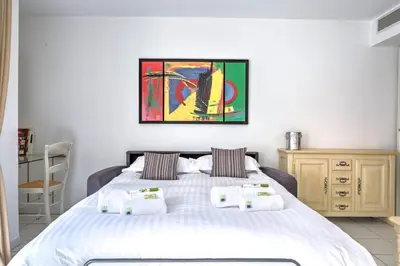 a bedroom with a bed with towels on it at IMMOGROOM - 3min from beach - AC - 10min from Palais - Wifi in Cannes