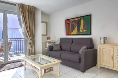 a living room with a couch and a glass table at IMMOGROOM - 3min from beach - AC - 10min from Palais - Wifi in Cannes