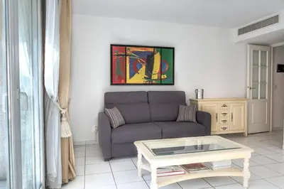 a living room with a couch and a coffee table at IMMOGROOM - 3min from beach - AC - 10min from Palais - Wifi in Cannes