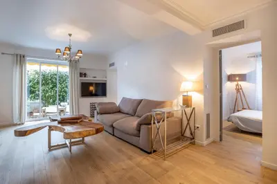 a living room with a couch and a bed at 3 pièces Luxe Croisette in Cannes