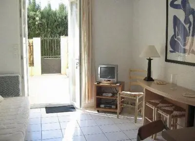 a living room with a tv and a table and a televisionictericterictericter at Croisette-Oasis in Cannes