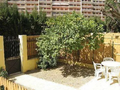a fence with a table and chairs and a tree at Croisette-Oasis in Cannes