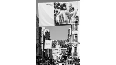 a black and white photo of a street with buildings at Colombe in Cannes