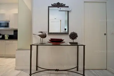 a table with a mirror in a room at Colombe in Cannes