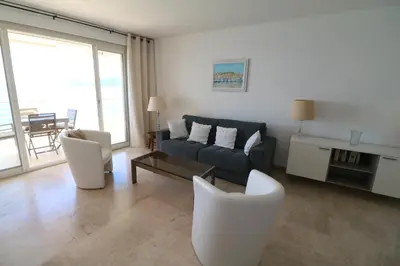 a living room with a couch and chairs and a table at Amazing sea view 2 bedroom beach front 303 in Cannes