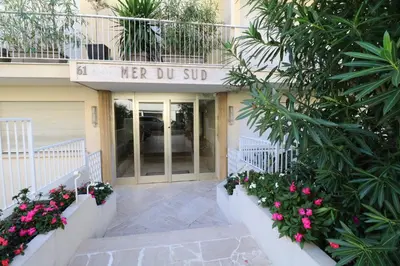 a building with a sign that reads her do sip at Amazing sea view 2 bedroom beach front 303 in Cannes