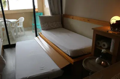 two bunk beds in a room with a table at Appartement Palm d'Azur in Cannes