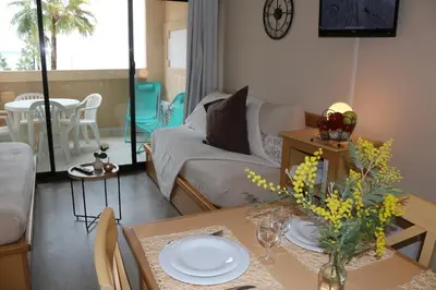 a living room with a couch and a table at Appartement Palm d'Azur in Cannes