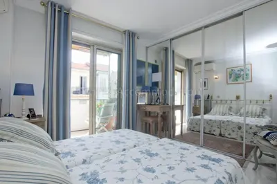 a bedroom with two beds and a large mirror at Isadora in Cannes