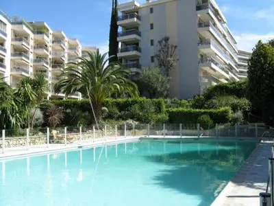 a large swimming pool in front of a large building at Karolina Properties - Ascot Appartement in Cannes