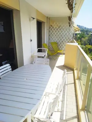 a balcony with a table and chairs on a balcony at Karolina Properties - Ascot Appartement in Cannes