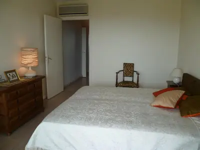 a bedroom with a bed and a dresser and a lamp at Karolina Properties - Ascot Appartement in Cannes