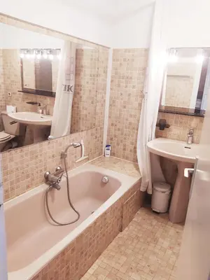 a bathroom with a tub and a sink at Karolina Properties - Ascot Appartement in Cannes