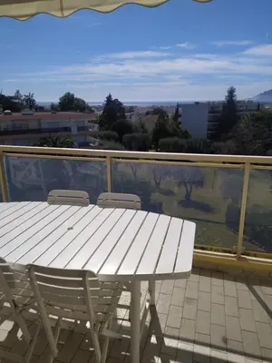 a white table and chairs on a balcony at Karolina Properties - Ascot Appartement in Cannes