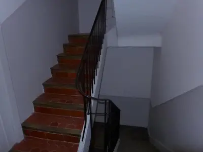 a stairway with a black rail and brick stairs at 1 Bedroom Notre Dame 2 mins from the Croisette and the Palais 225 in Cannes