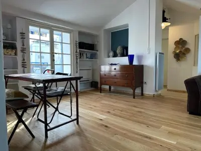 a living room with a table and a dresser at Chez Nella in Cannes