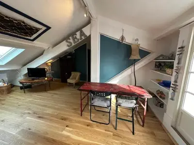 a living room with a table and chairs in a room at Chez Nella in Cannes