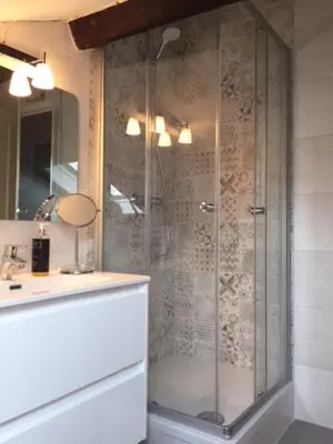 a shower with a glass door in a bathroom at Chez Nella in Cannes